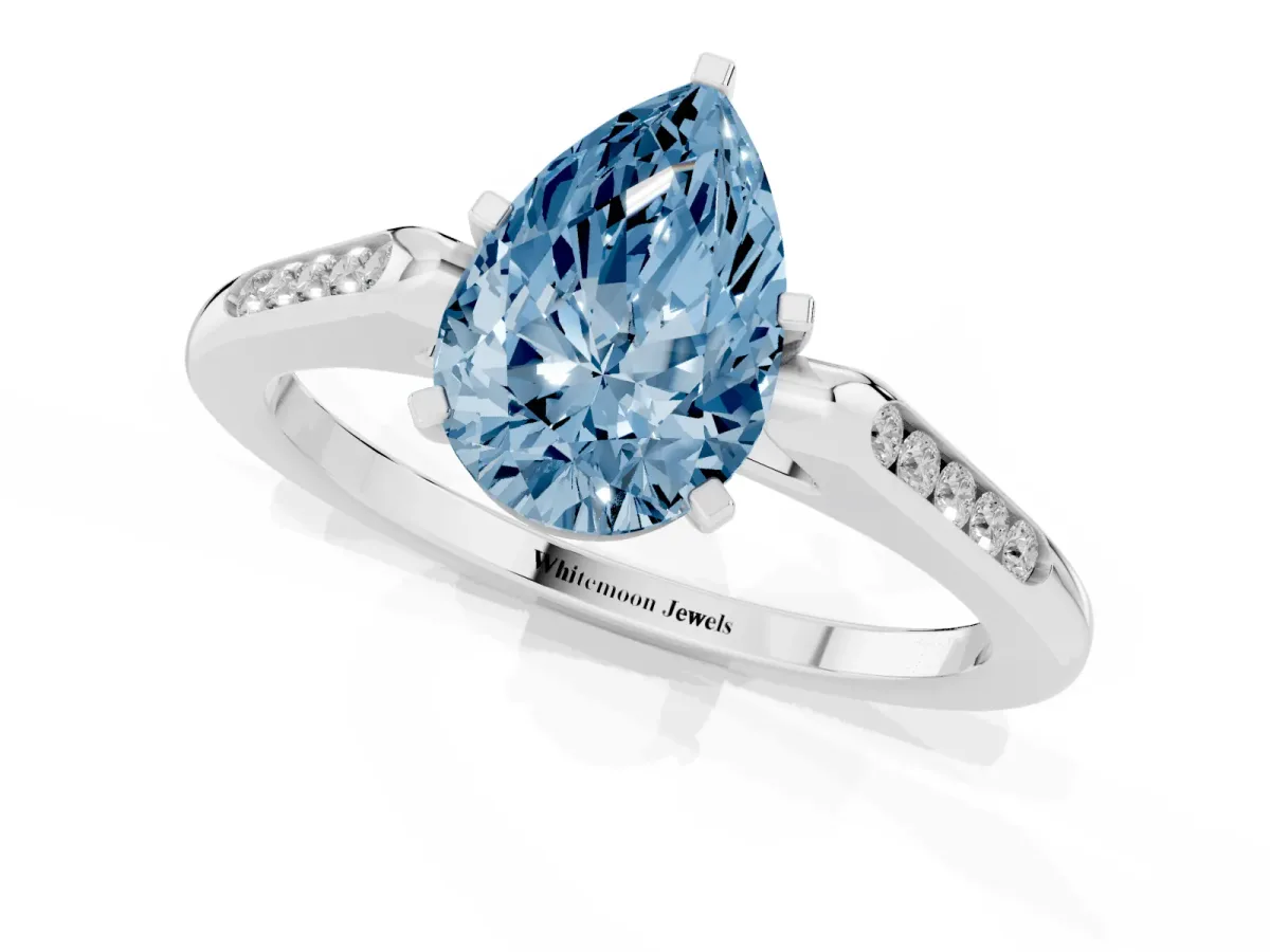 Fancy Blue Pear Cut Diamond Solitaire Ring with Channel Set Round Band and Prong Setting Silver