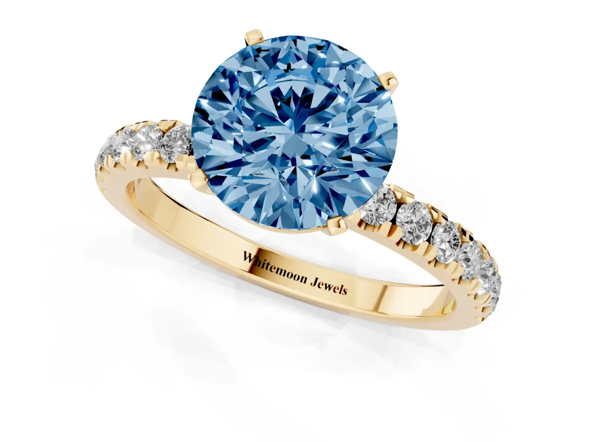 Fancy Blue Round Cut Diamond Solitaire Ring with Pavé Accents and Four-Prong Setting Yellow gold