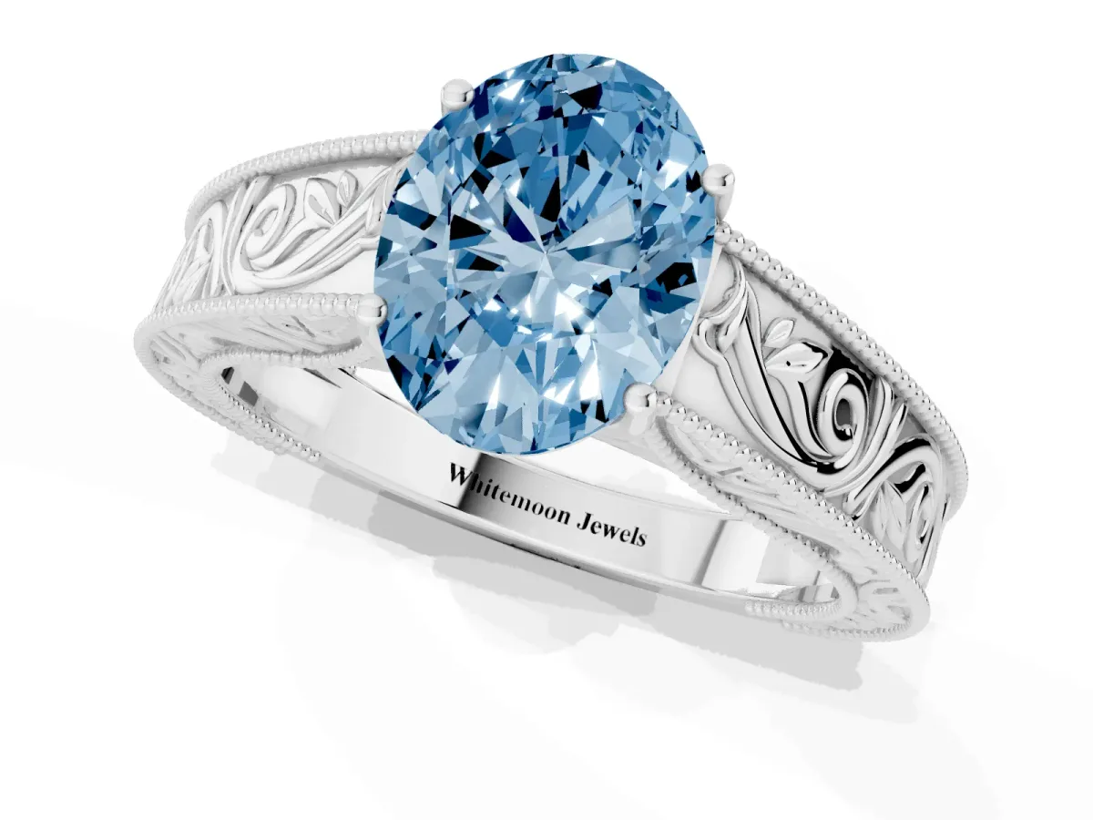 Fancy Blue Oval Cut Diamond Solitaire Ring with Engraved Band and Four-Prong Setting Silver