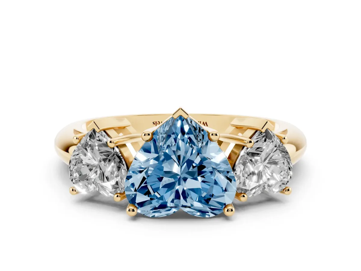 Fancy Blue Three-Stone Heart Cut Cut Diamond Engagement Ring with Prong Setting on a White Gold Band Yellow gold