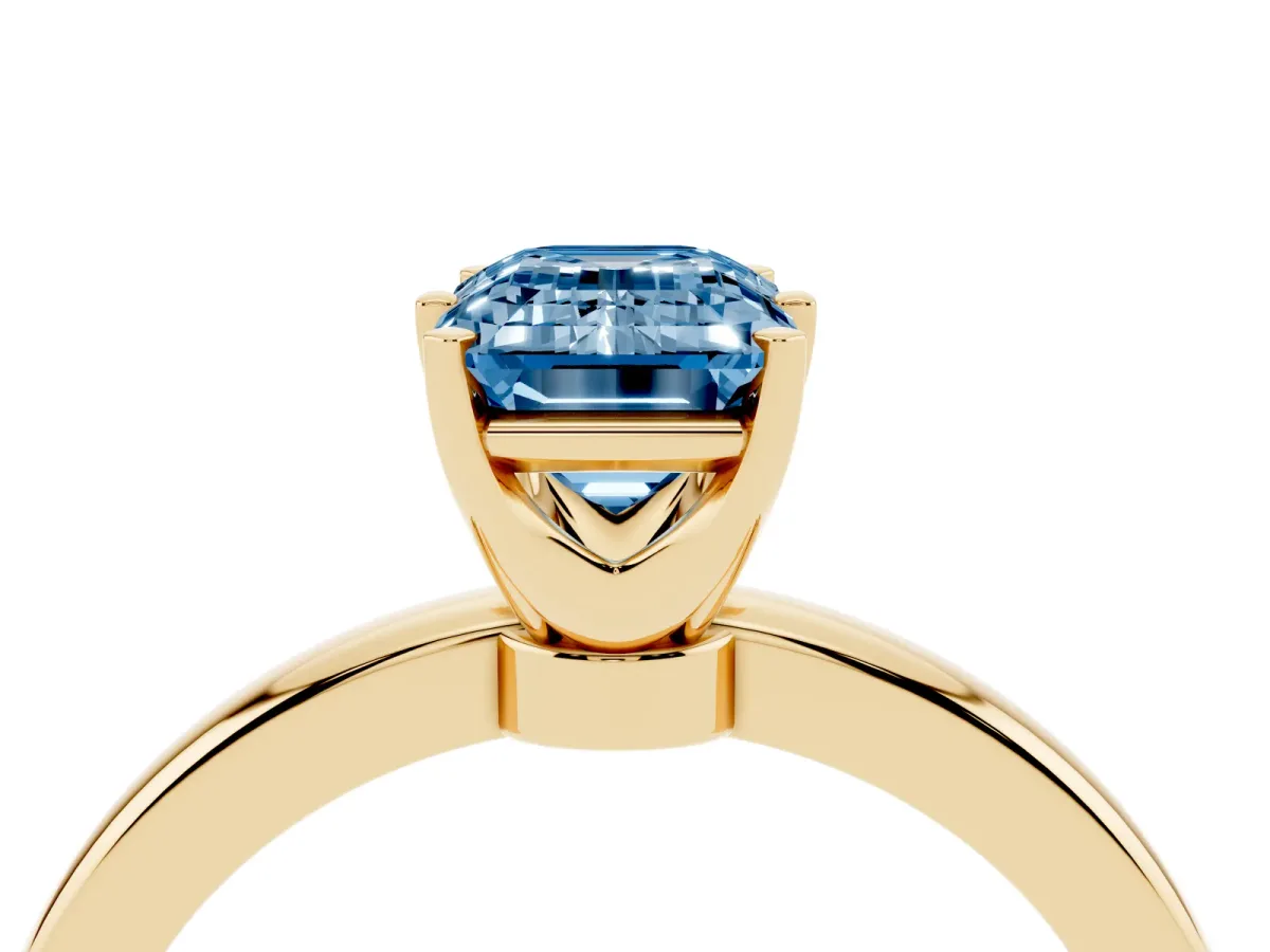 Fancy Blue Emerald Cut Solitaire Diamond Ring with Six-Prong Setting on a Classic Band Yellow gold