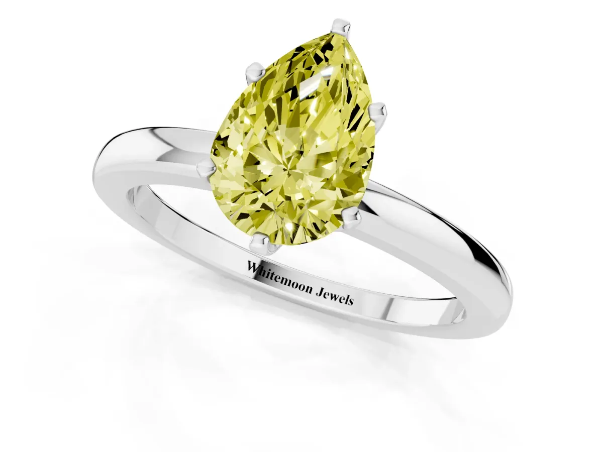 Fancy Yellow Pear Cut Solitaire Diamond Ring with Six-Prong Setting on a Classic Band Silver