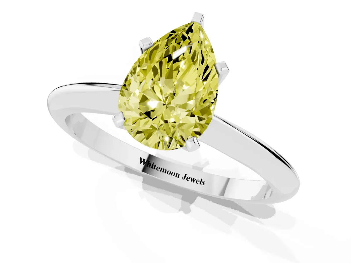 Fancy Yellow Pear Cut Cut Solitaire Ring with Four-Prong Setting on a Classic Band Silver