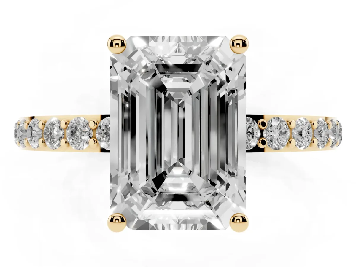Emerald Cut Diamond Solitaire Ring with Round Pavé Shoulders and Prong Setting Yellow gold