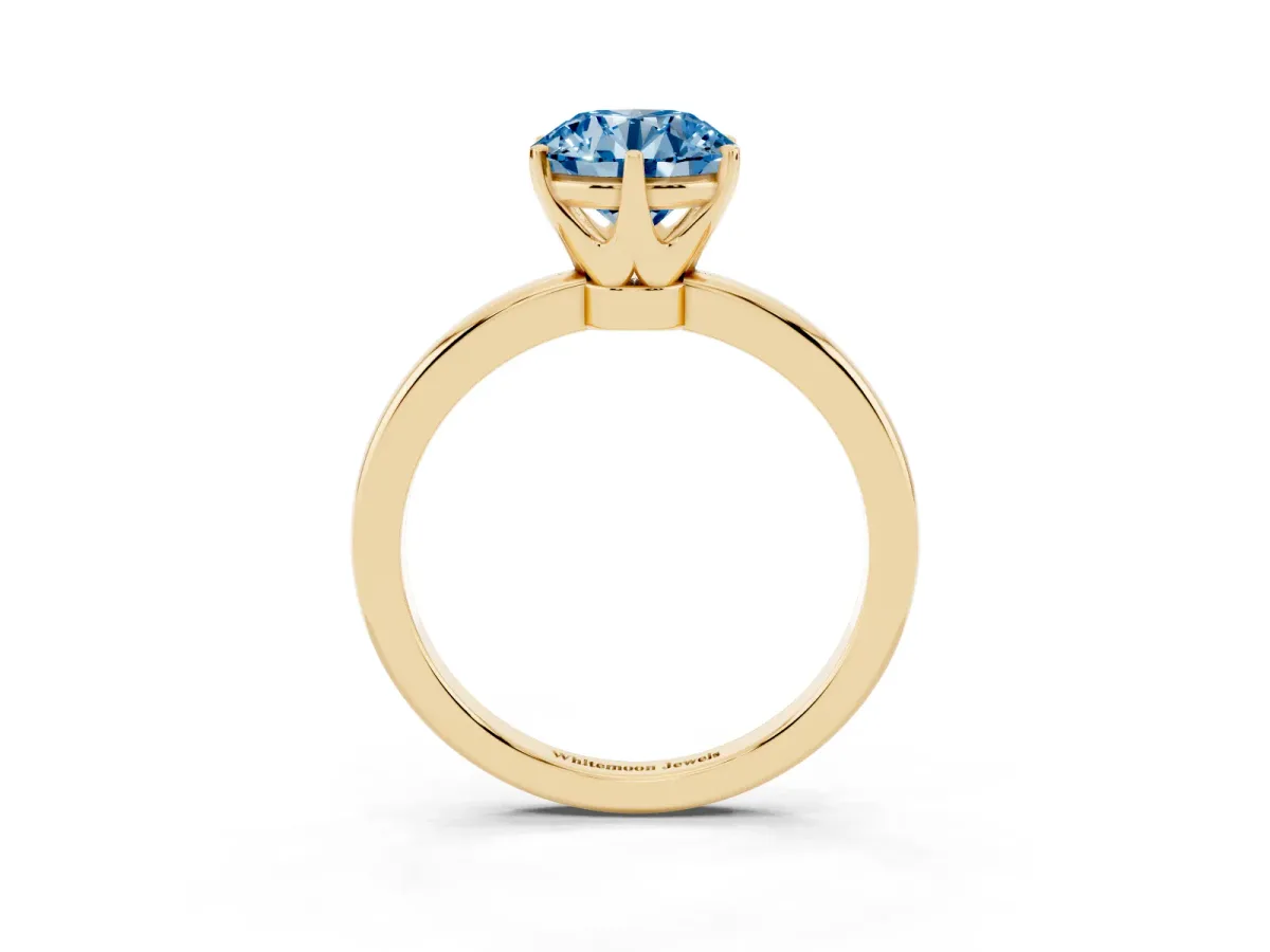Fancy Blue Round Cut Solitaire Diamond Ring with Six-Prong Setting on a Classic Band Yellow gold