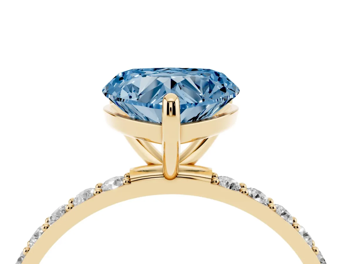 Fancy Blue Heart Cut Diamond Solitaire Ring with Round Pavé Band and Prong Setting Yellow gold