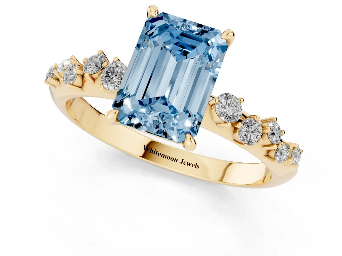Fancy Blue Emerald Cut Diamond Cluster Side Stone Solitaire Ring with Prong Setting Yellow gold