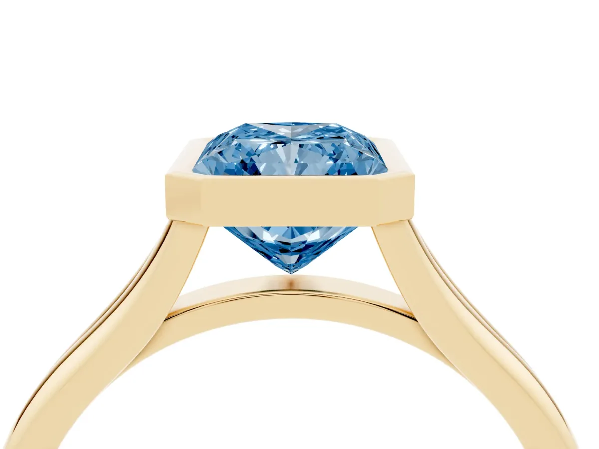 Fancy Blue Bezel Set Radiant Cut Cut Solitaire Ring with Tapered Band Yellow gold