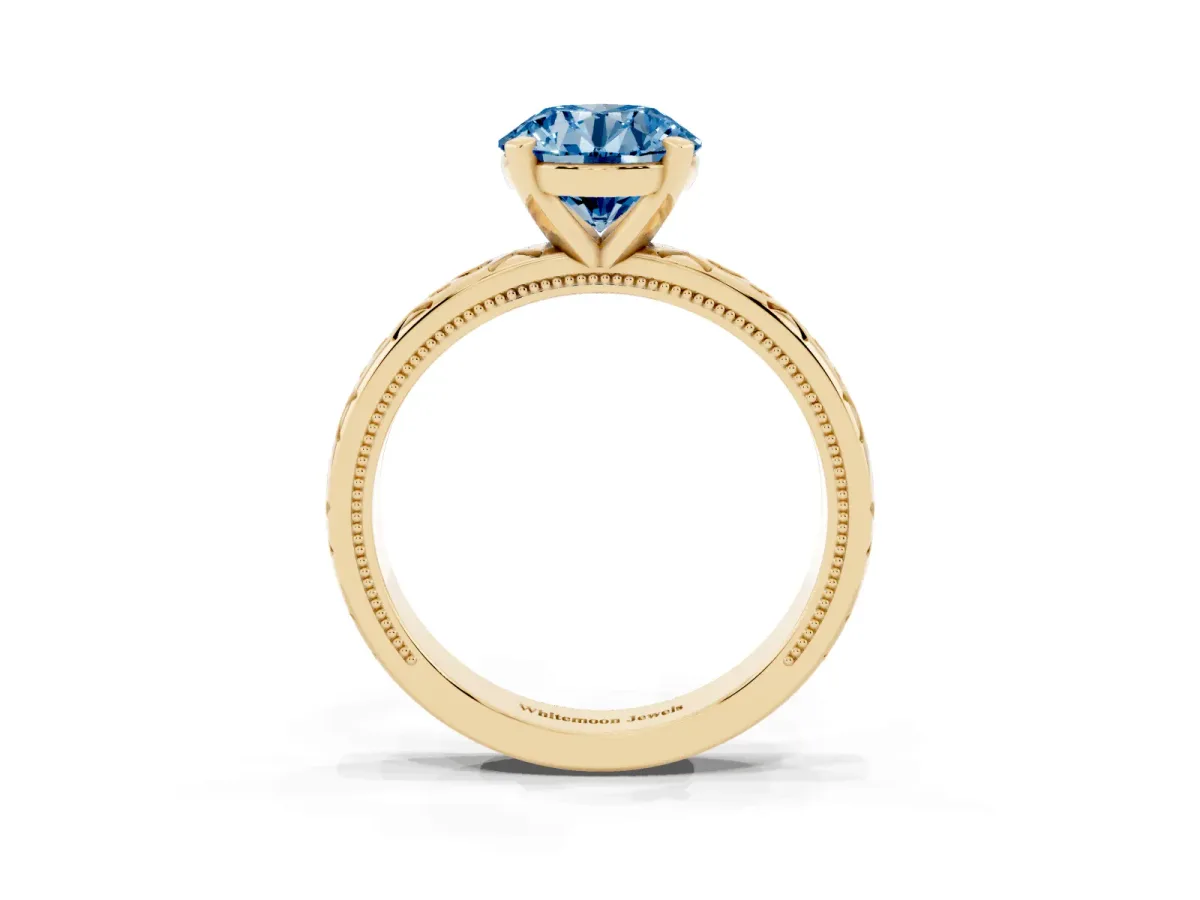 Fancy Blue Round Cut Solitaire Engagement Ring with Scrollwork Band and Four-Prong Setting Yellow gold