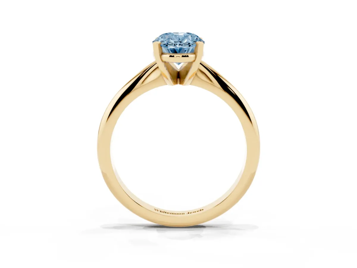 Fancy Blue Oval Cut Cut Solitaire Ring with Four-Prong Setting on a Classic Band Yellow gold