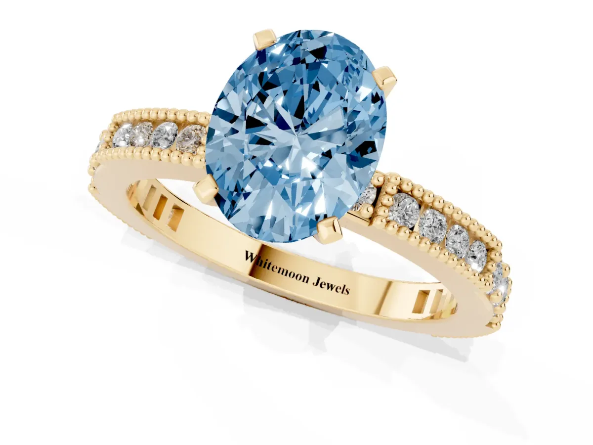 Fancy Blue Oval Cut Solitaire with Pavé Band and Four-Prong Setting Yellow gold