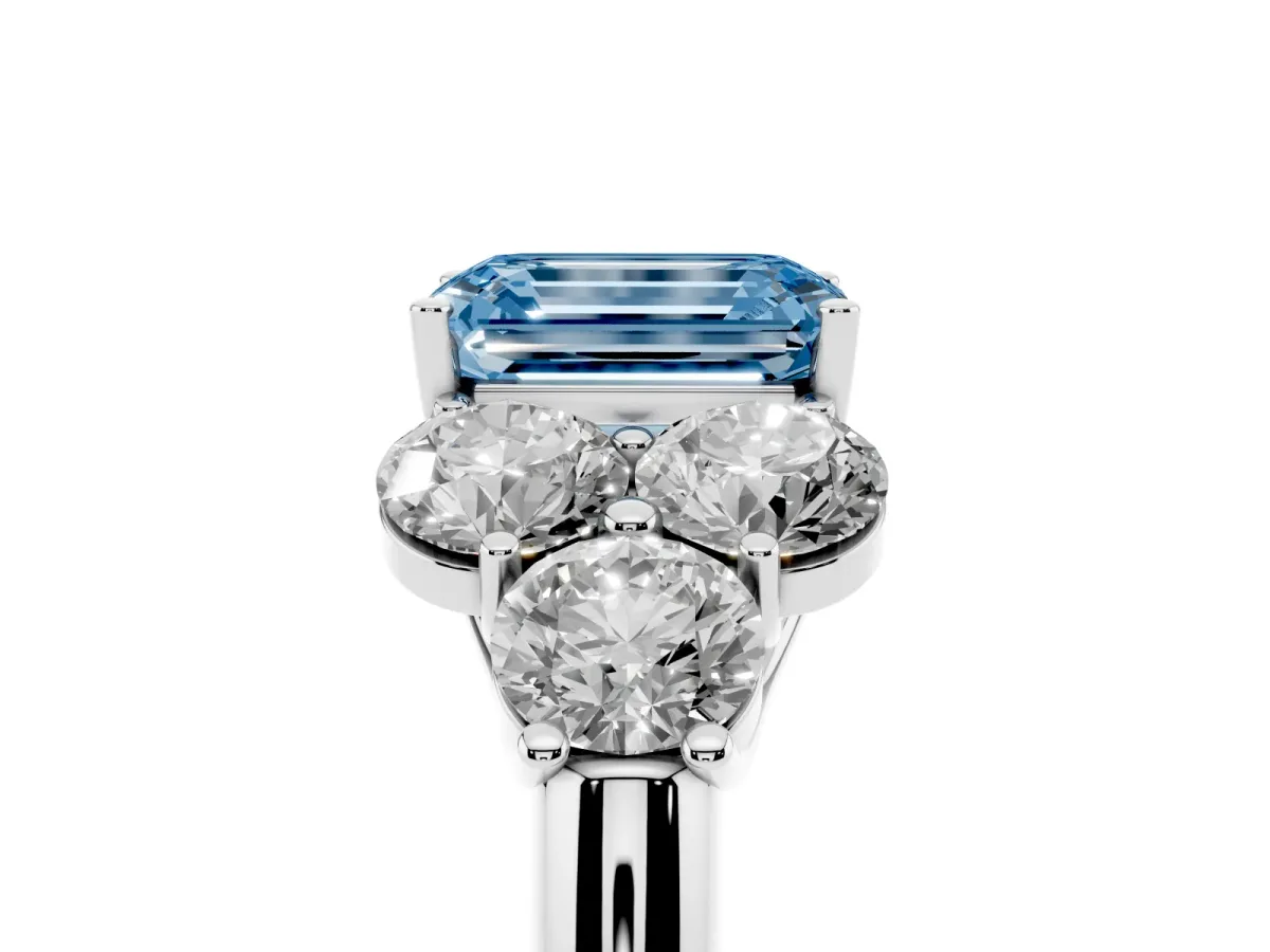 Fancy Blue Emerald Cut Cut Diamond Cluster Ring with Round Accent Stones and Prong Setting on a Classic Band White gold
