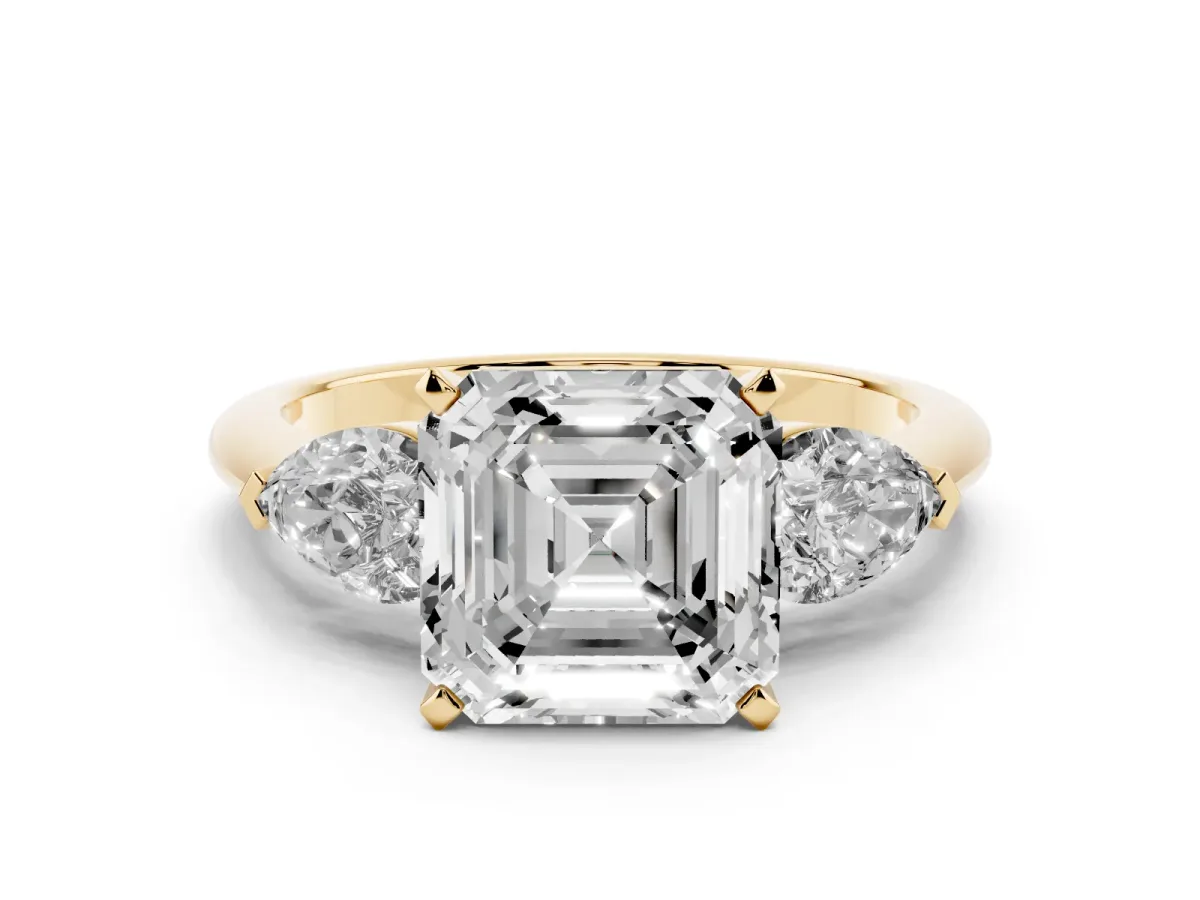 Three-Stone Asscher Cut Diamond Ring with Pear Side Stones and Four-Prong Setting Yellow gold