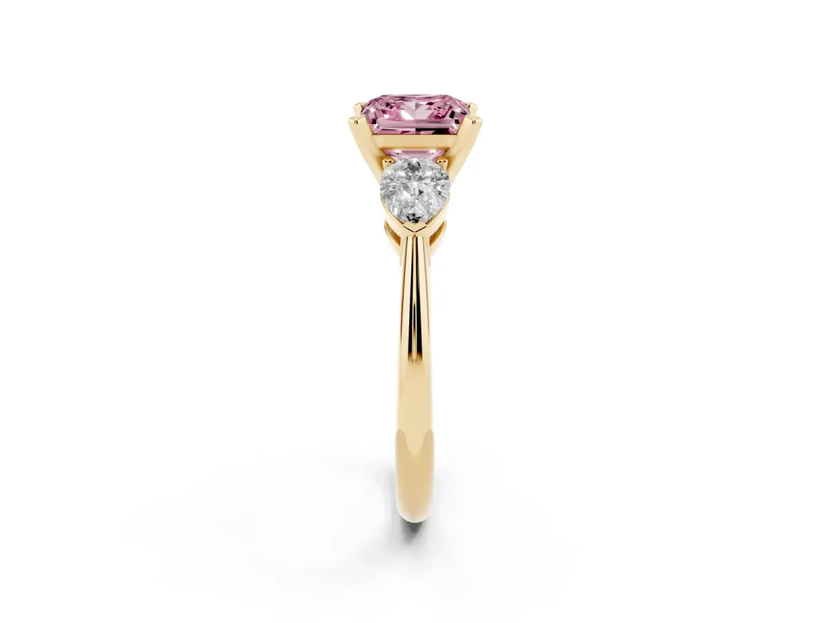 Fancy Pink Three-Stone Princess Cut Diamond Ring with Pear Side Stones and Four-Prong Setting Yellow gold