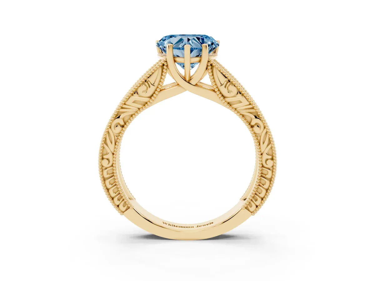 Fancy Blue Heart Cut Diamond Solitaire Ring with Engraved Band and Four-Prong Setting Yellow gold