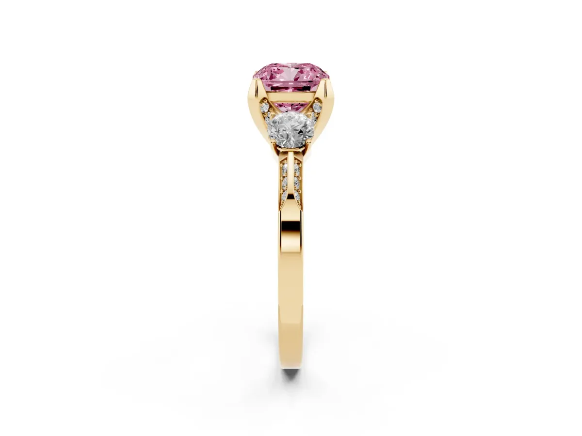 Fancy Pink Cushion Cut Brilliant Three-Stone Diamond Ring with Pavé Band and Four-Prong Setting Yellow gold