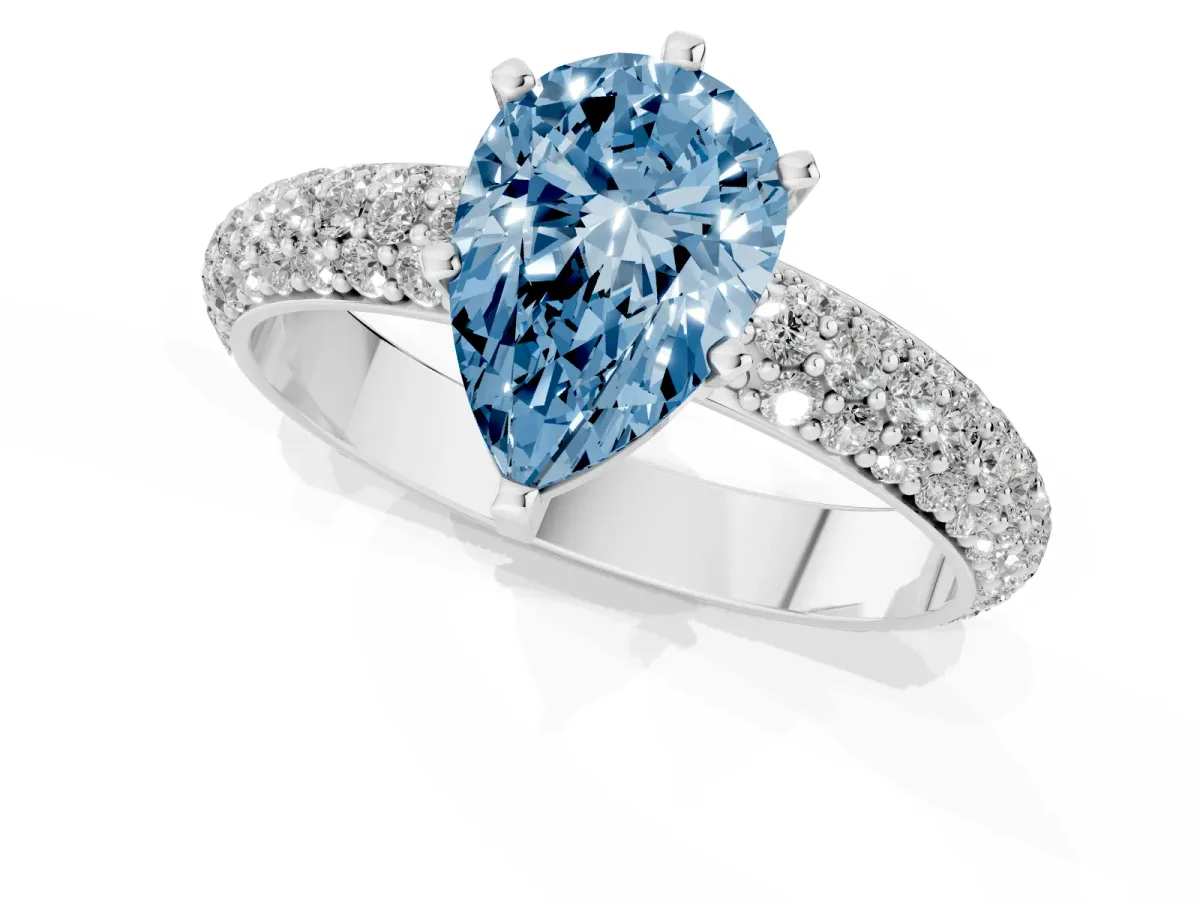 Fancy Blue Pear Cut Diamond Solitaire Ring with Prong Setting and Pavé Band Silver