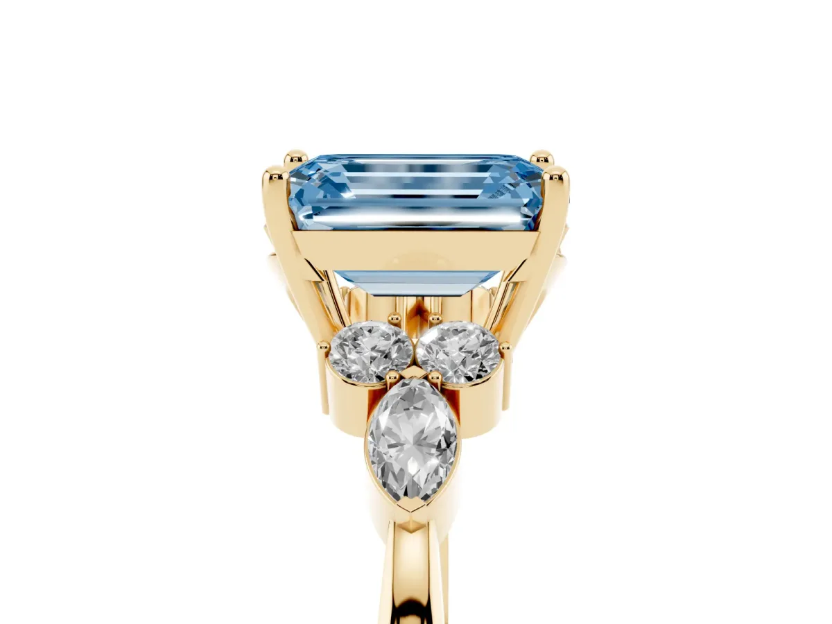 Fancy Blue Emerald Cut Brilliant Diamond Solitaire Ring with Pear Side Stones and Four-Prong Setting Yellow gold