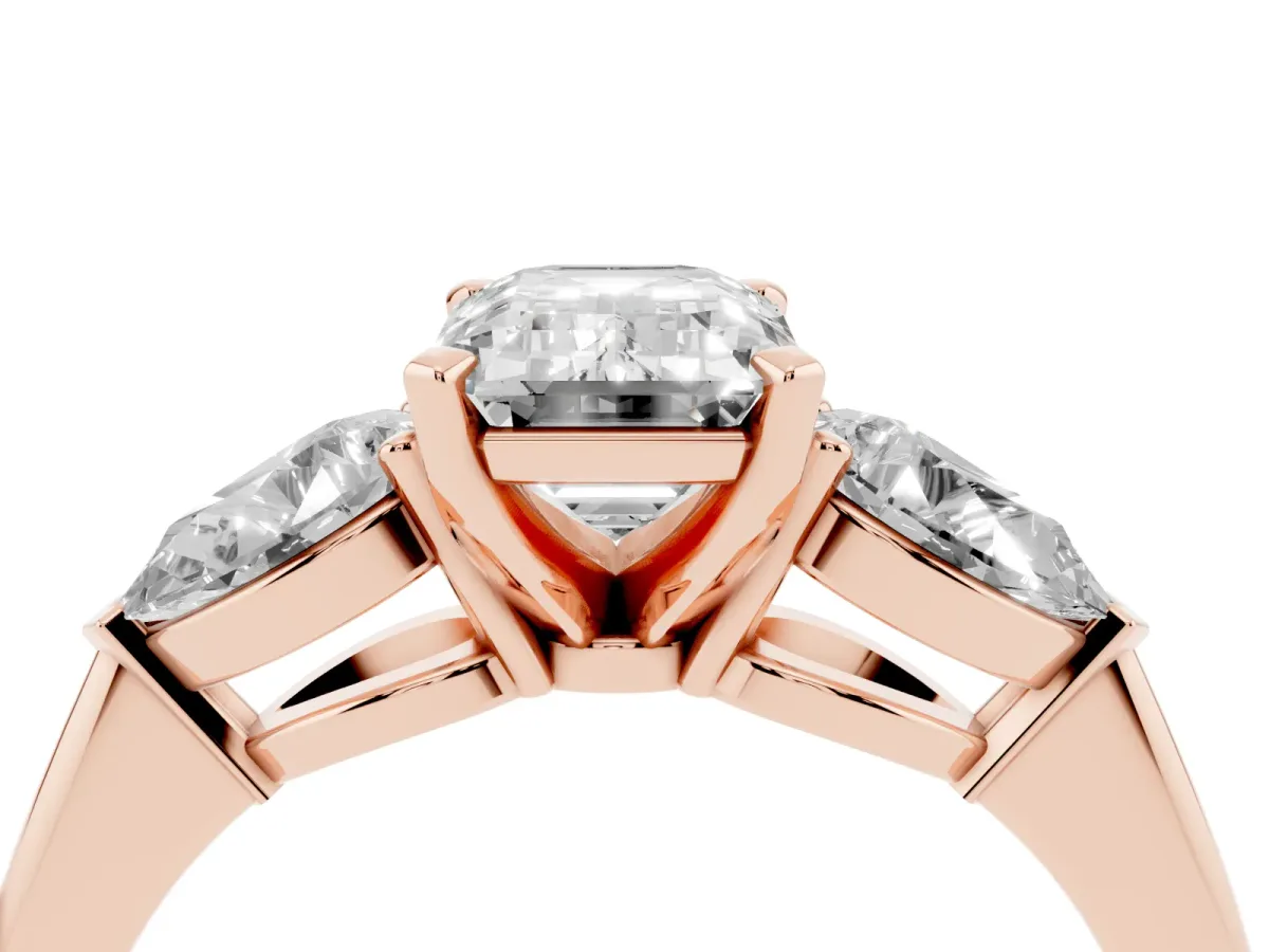 Three-Stone Emerald Cut Diamond Ring with Pear Side Stones and Four-Prong Setting Rose gold