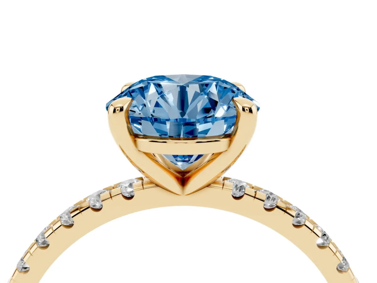 Fancy Blue Round Cut Diamond Brilliant Solitaire Ring with Pavé Band and Four-Prong Setting Yellow gold
