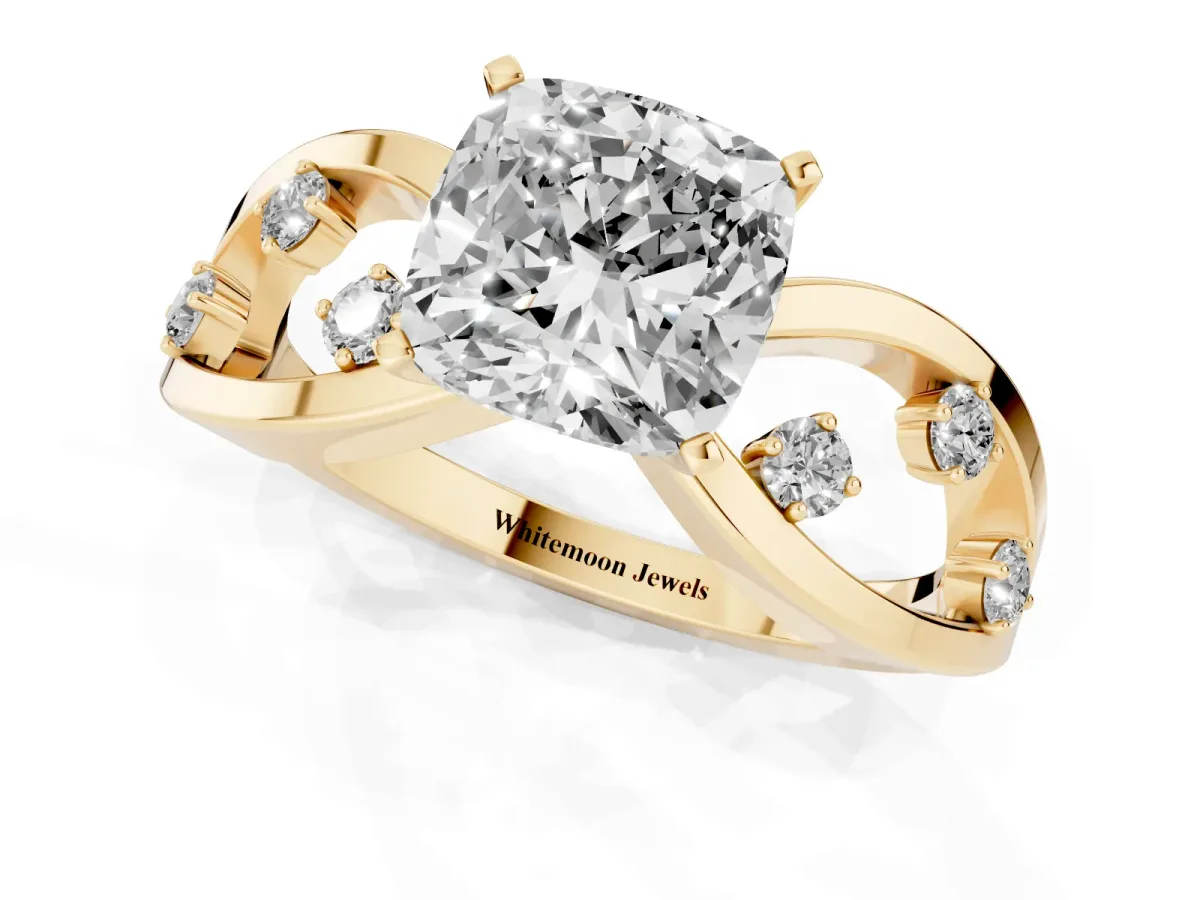 Cushion Cut Cut Solitaire Diamond with Side Stones on Criss-Cross Band and Four-Prong Setting Yellow gold