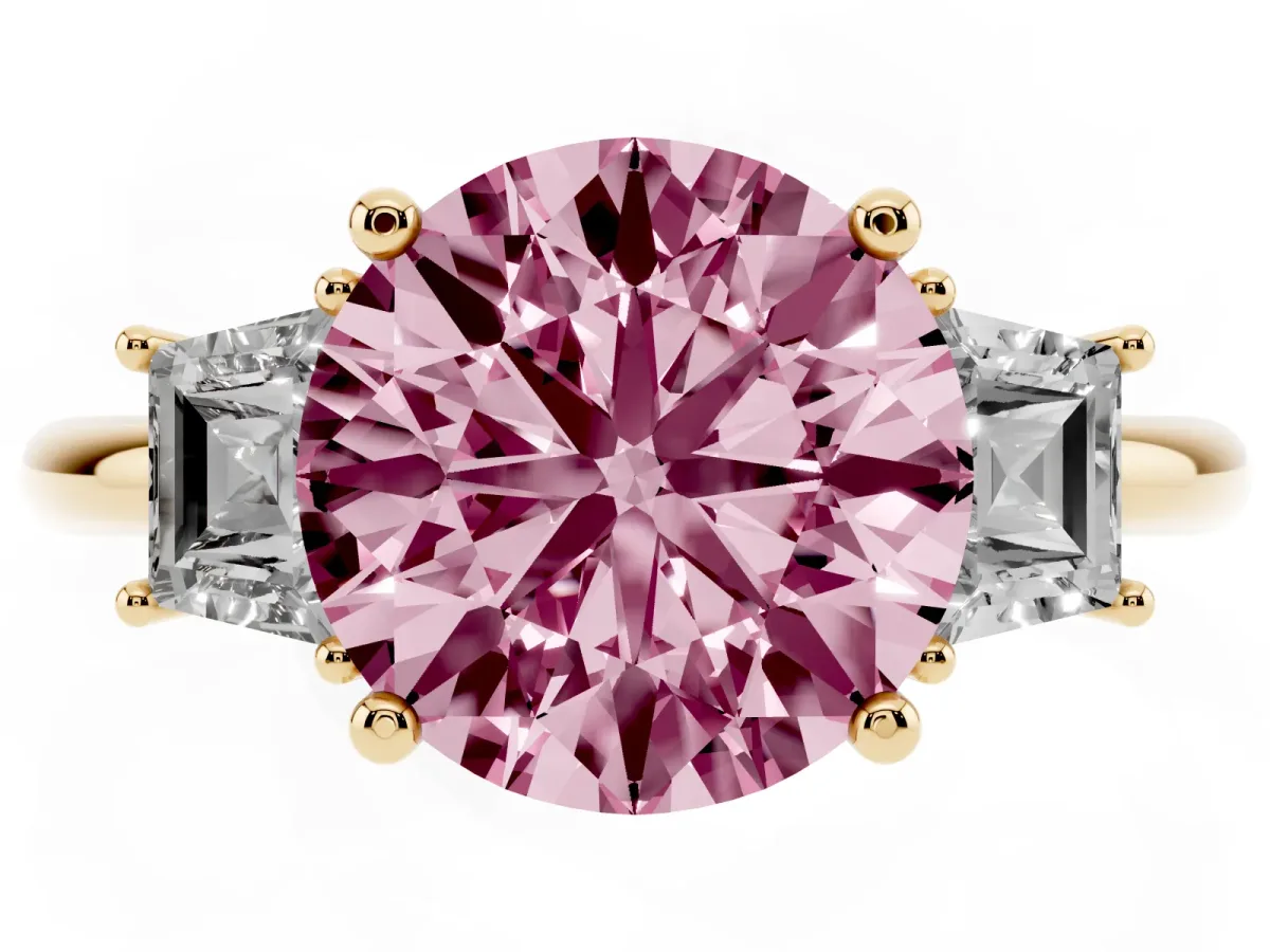Fancy Pink Round Cut Diamond Three-Stone Ring with Trapezoid Side Stones and Prong Setting Yellow gold