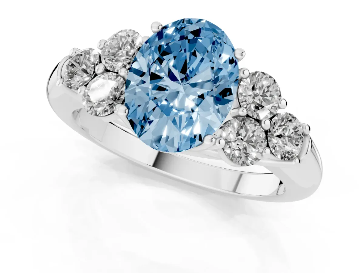 Fancy Blue Oval Cut Cut Diamond Cluster Ring with Round Accent Stones and Prong Setting on a Classic Band Silver
