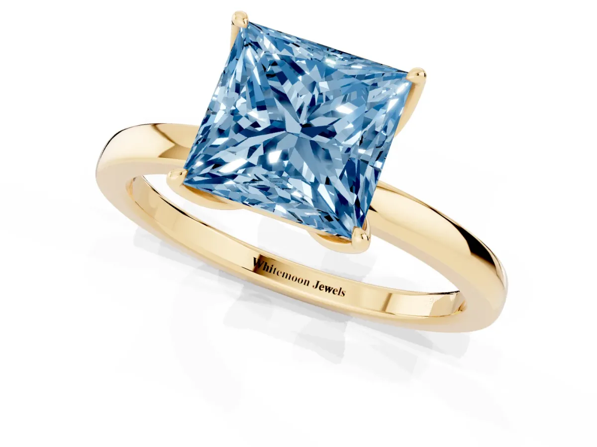 Fancy Blue Princess Cut Diamond Solitaire Ring with Thin Band and Prong Setting Yellow gold