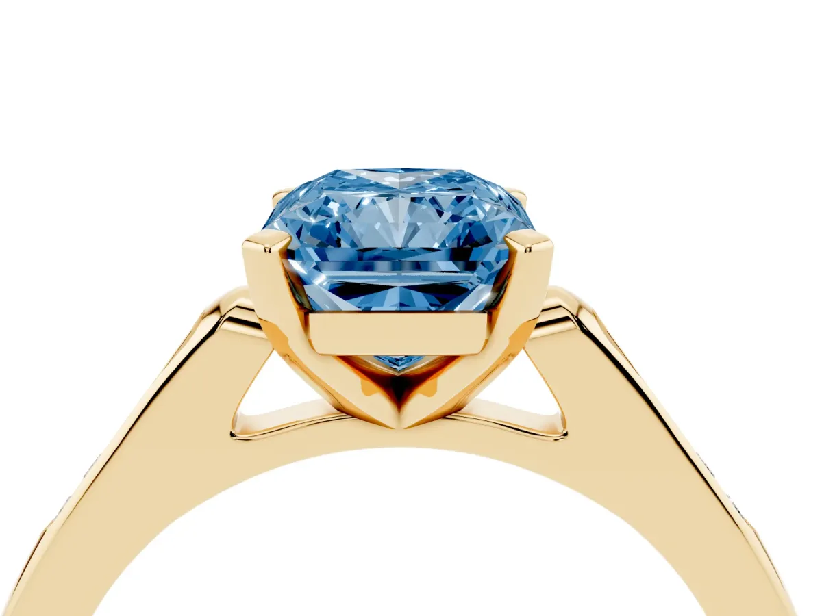 Fancy Blue Radiant Cut Diamond Solitaire Ring with Channel Set Round Band and Prong Setting Yellow gold