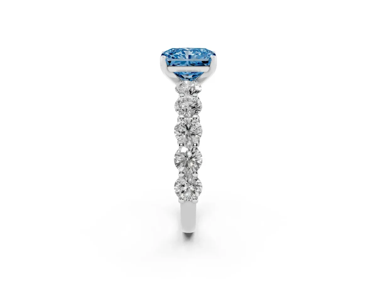 Fancy Blue Radiant Cut Diamond Prong Setting with Side Stones on a Pave Band Platinum