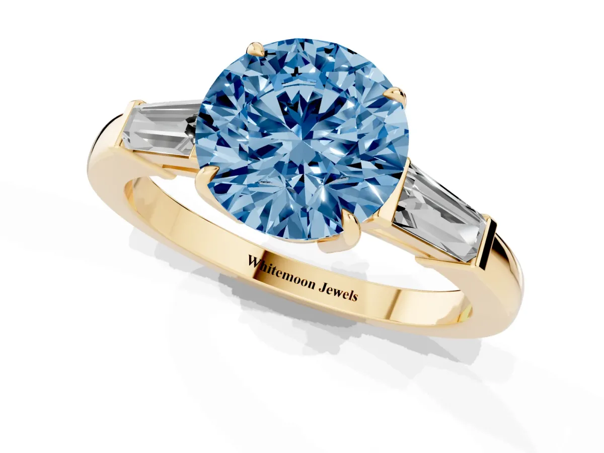 Fancy Blue Round Cut Diamond Three-Stone Ring with Tapered Baguette Side Stones and Prong Setting Yellow gold