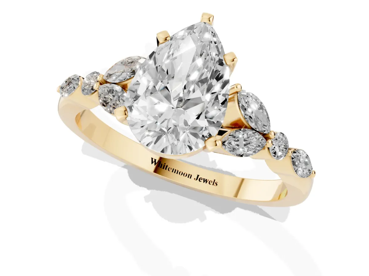 Pear Cut Diamond Solitaire Ring with Side Stones and Four-Prong Setting Yellow gold