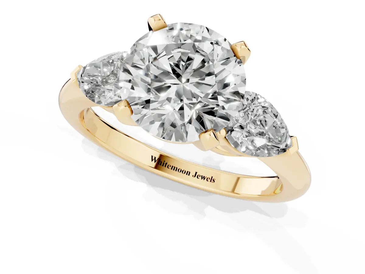 Three-Stone Round Cut Diamond Ring with Pear Side Stones and Four-Prong Setting Yellow gold
