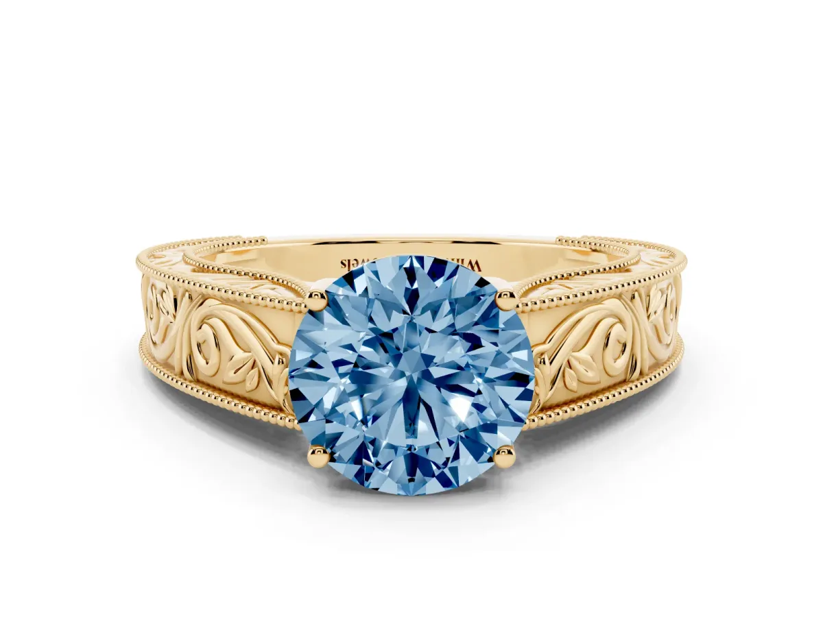 Fancy Blue Round Cut Diamond Solitaire Ring with Engraved Band and Four-Prong Setting Yellow gold