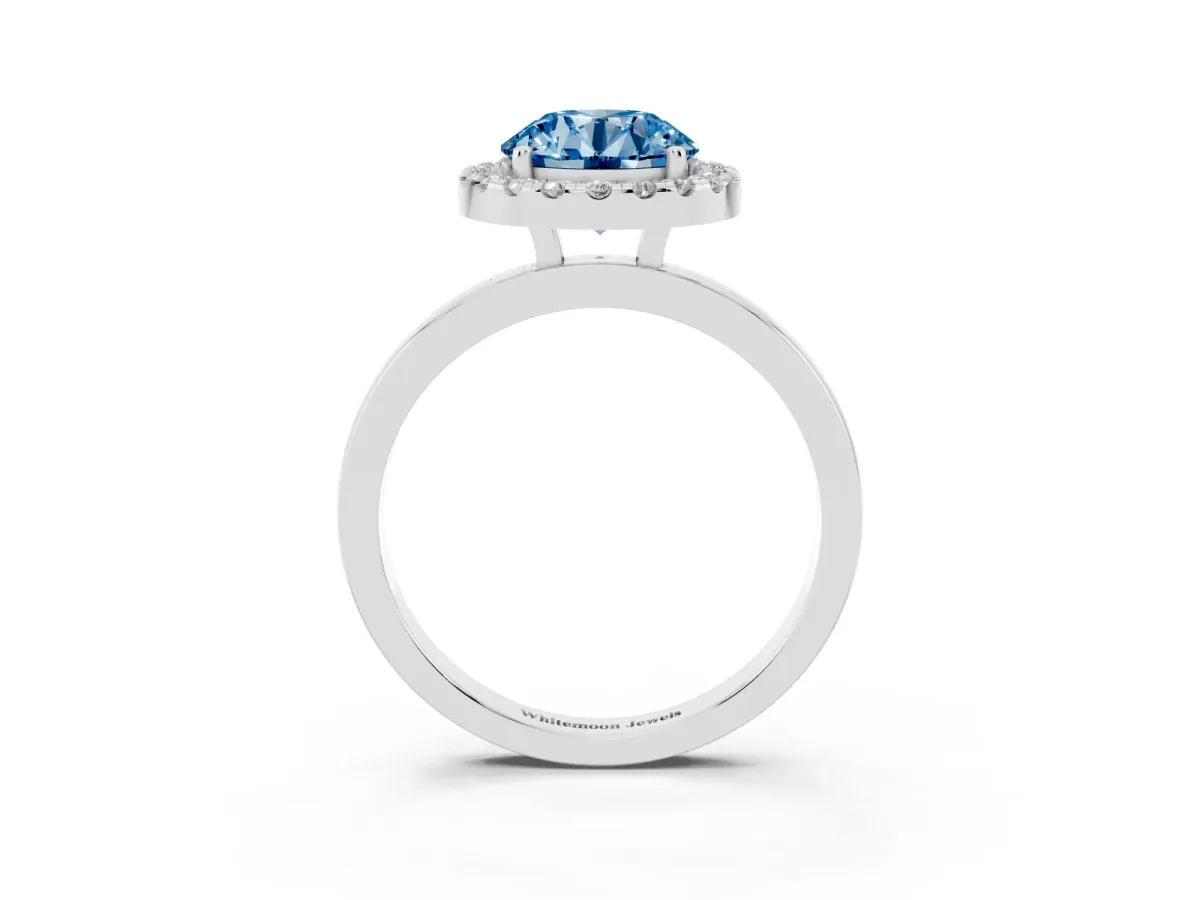 Fancy Blue Round Cut Halo Diamond Solitaire with Pavé Band and Four-Prong Setting Silver