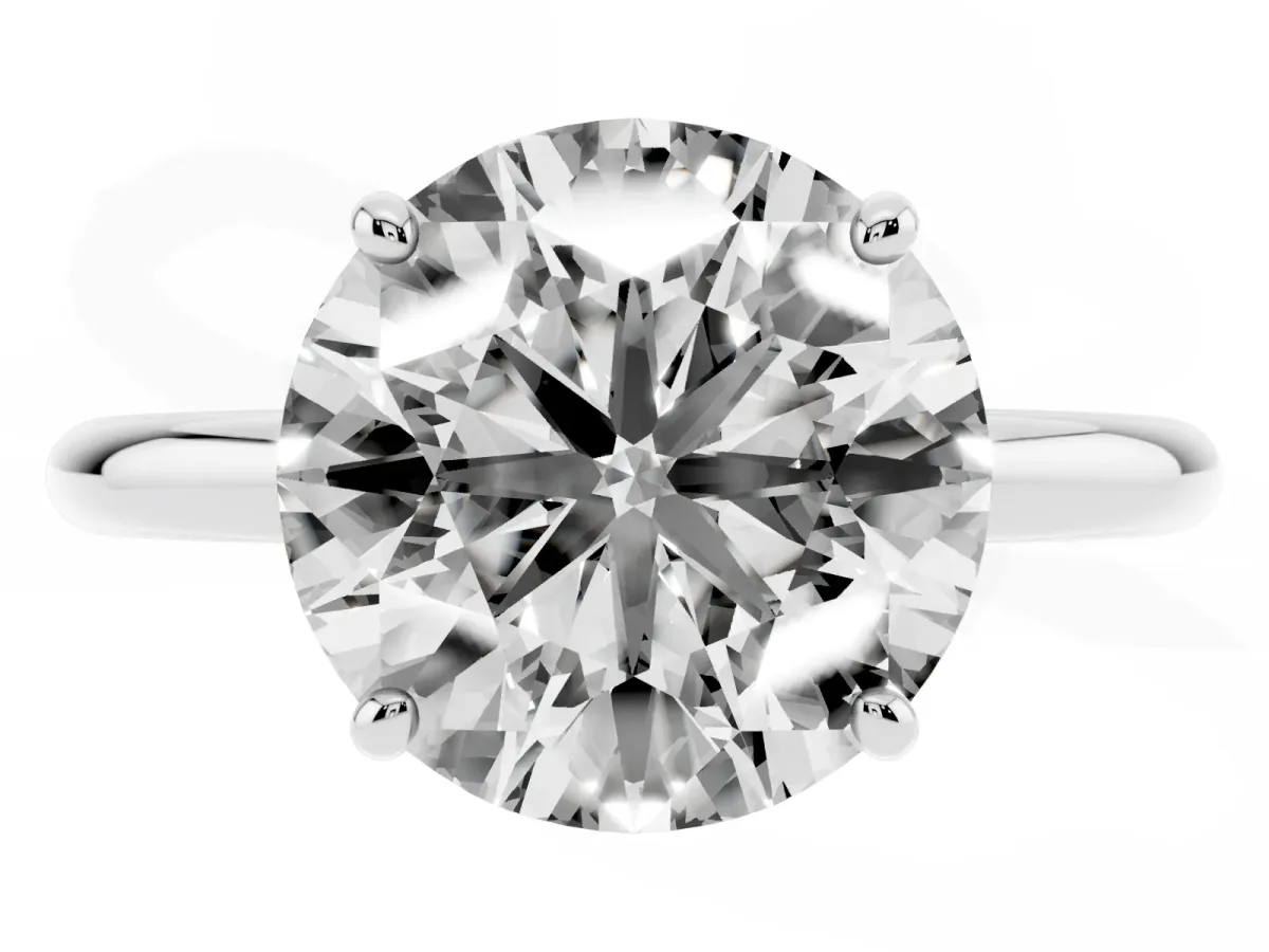 Round Cut Solitaire Diamond Ring with Four-Prong Setting on a Plain Band Platinum