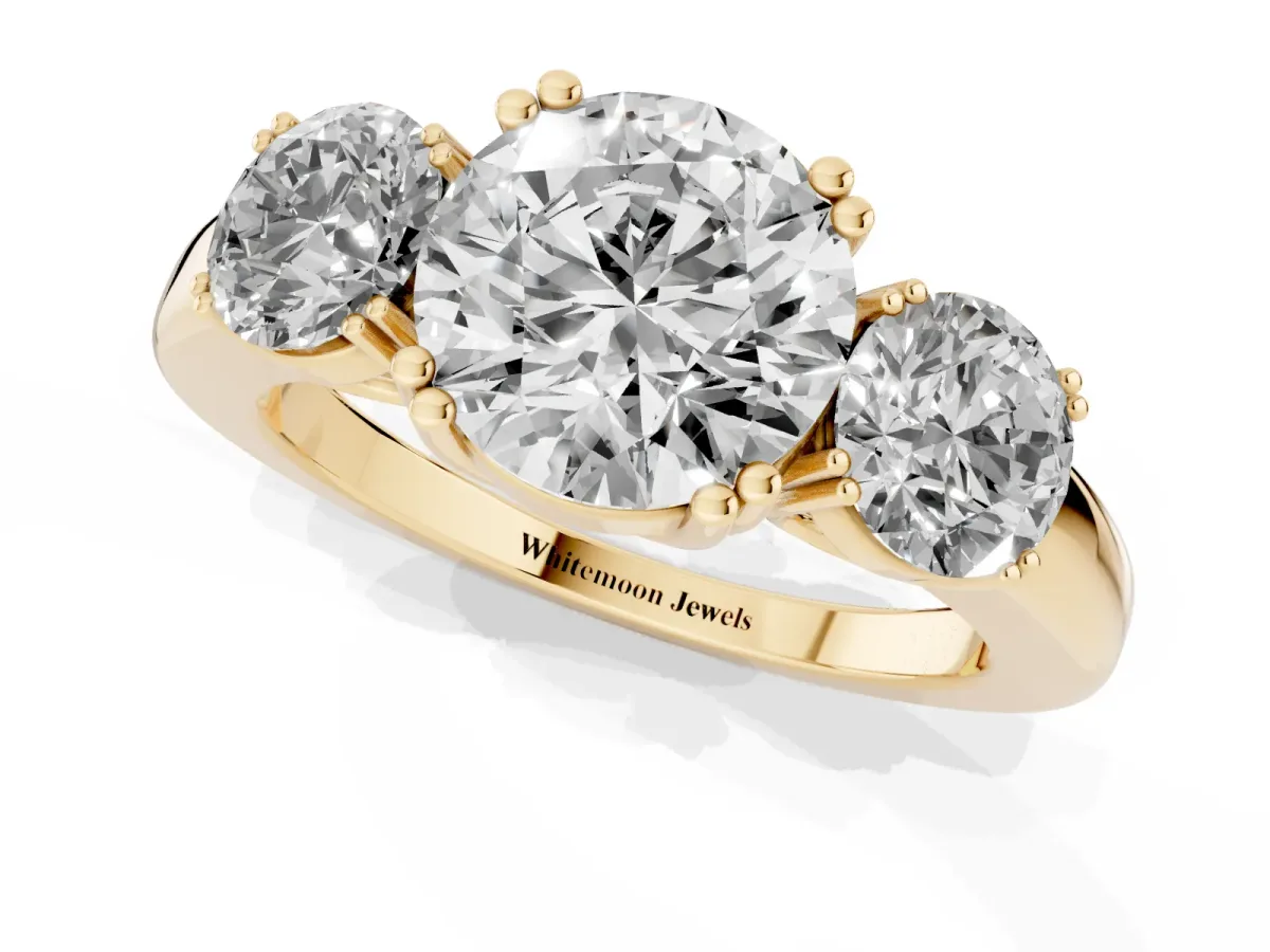 Three-Stone Round Cut Cut Diamond Ring with Channel Set Band and Four-Prong Setting Yellow gold