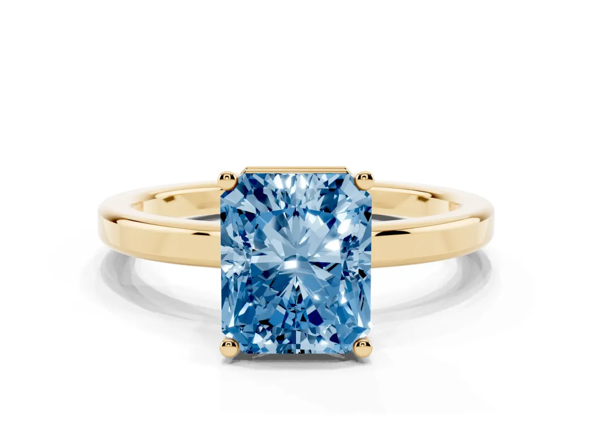 Fancy Blue Radiant Cut Cut Solitaire Engagement Ring with Four-Prong Setting on a Classic Band Yellow gold