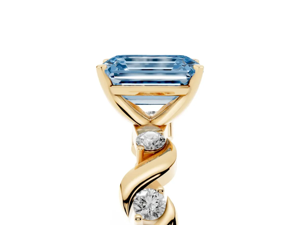 Fancy Blue Emerald Cut Diamond Solitaire Twisted Band with Round Accents and Prong Setting Yellow gold