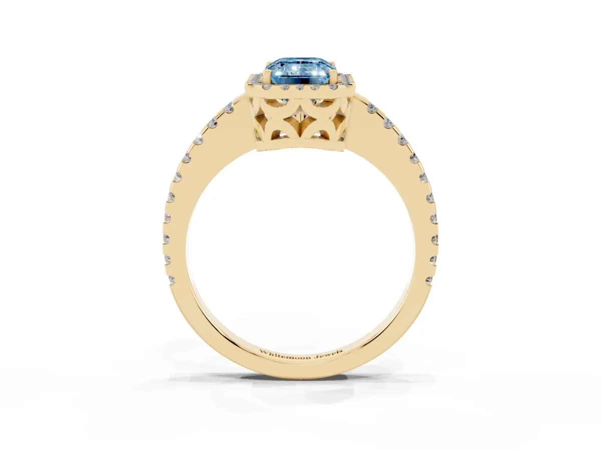 Fancy Blue Emerald Cut Diamond Halo Engagement Ring with Pavé Band and Prong Setting Yellow gold