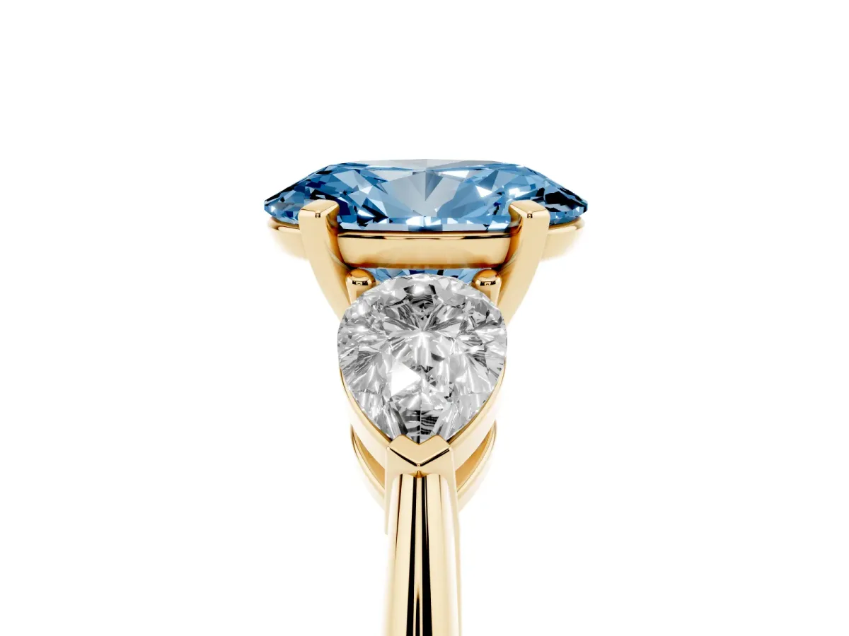 Fancy Blue Three-Stone Oval Cut Diamond Ring with Pear Side Stones and Four-Prong Setting Yellow gold