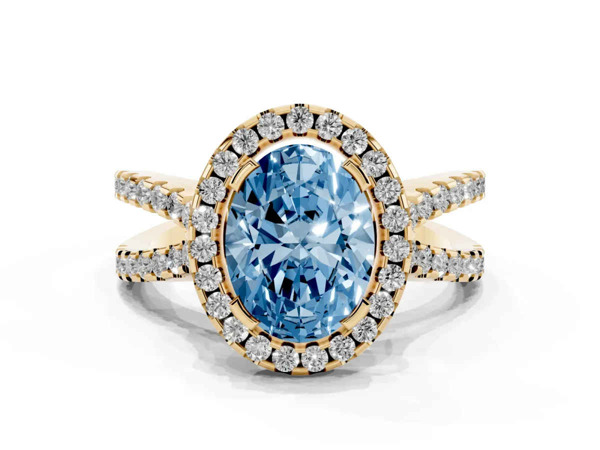 Fancy Blue Oval Cut Diamond Halo Ring with Split Shank Pavé Band and Prong Setting Yellow gold