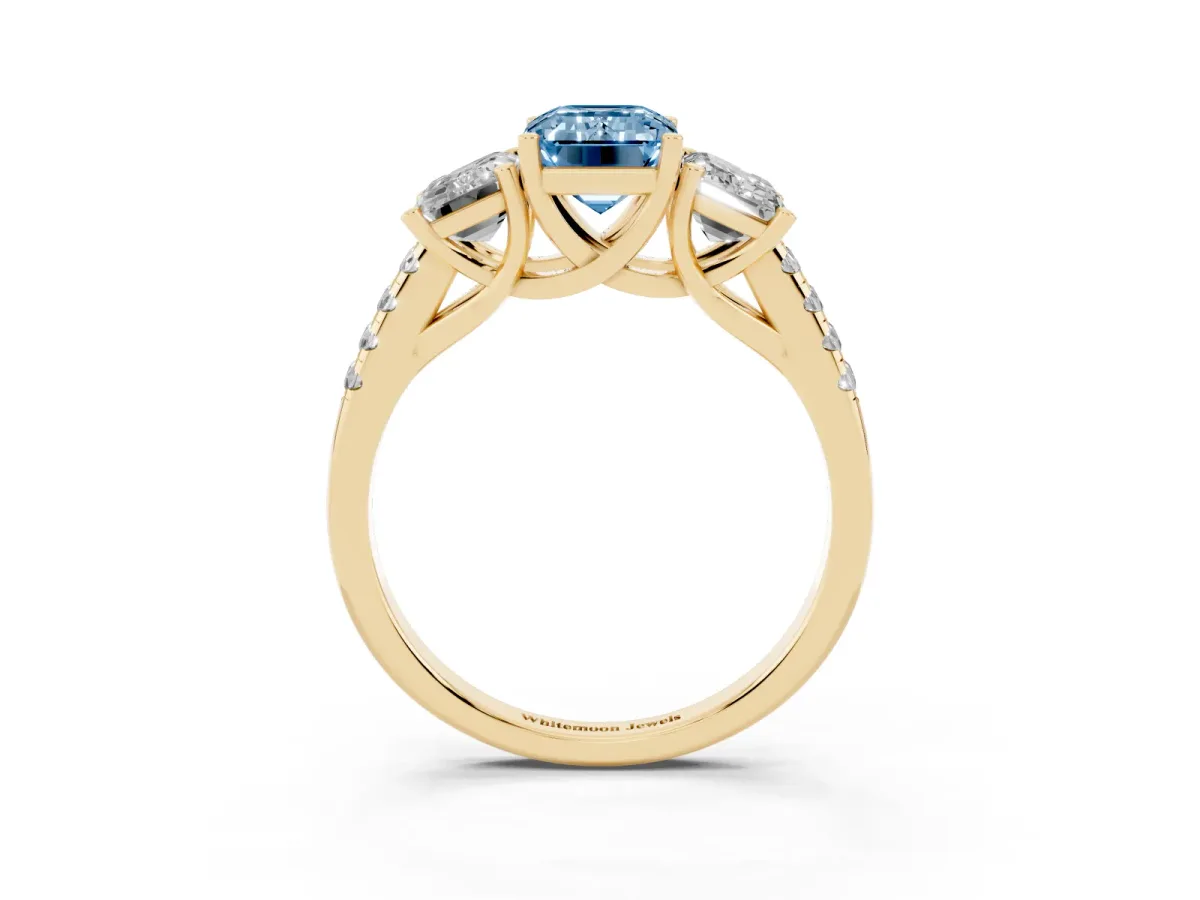 Fancy Blue Three-Stone Emerald Cut Diamond Ring with Round Pavé Band and Prong Setting Yellow gold