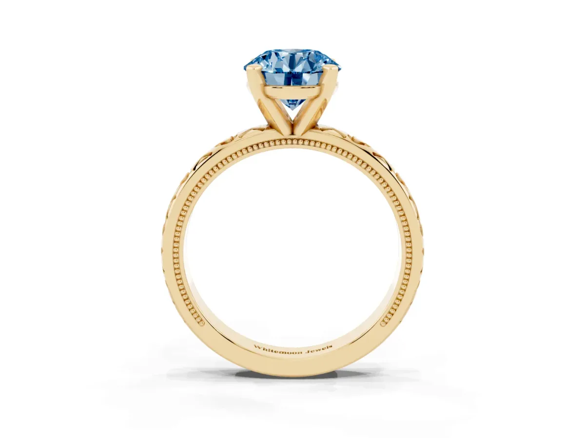 Fancy Blue Round Cut Solitaire Diamond Engagement Ring with XO Engraved Band and Four-Prong Setting Yellow gold