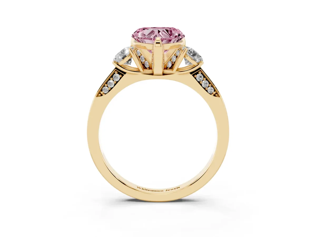 Fancy Pink Heart Cut Brilliant Three-Stone Diamond Ring with Pavé Band and Four-Prong Setting Yellow gold