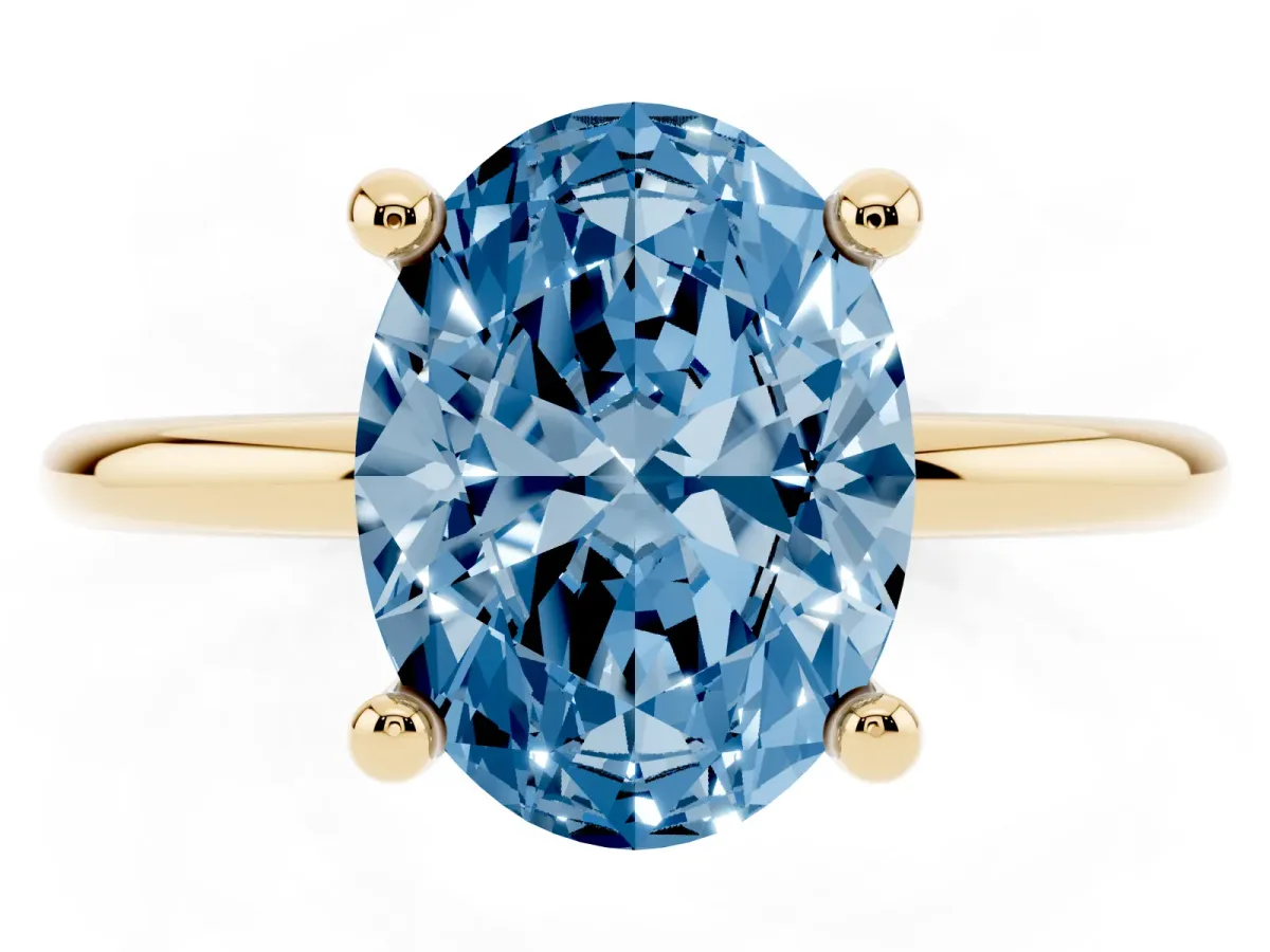 Fancy Blue Oval Cut Solitaire Diamond Ring with 4-Prong Setting on a Classic Band Yellow gold