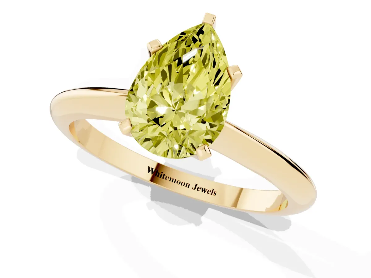 Fancy Yellow Pear Cut Cut Solitaire Ring with Four-Prong Setting on a Classic Band Yellow gold