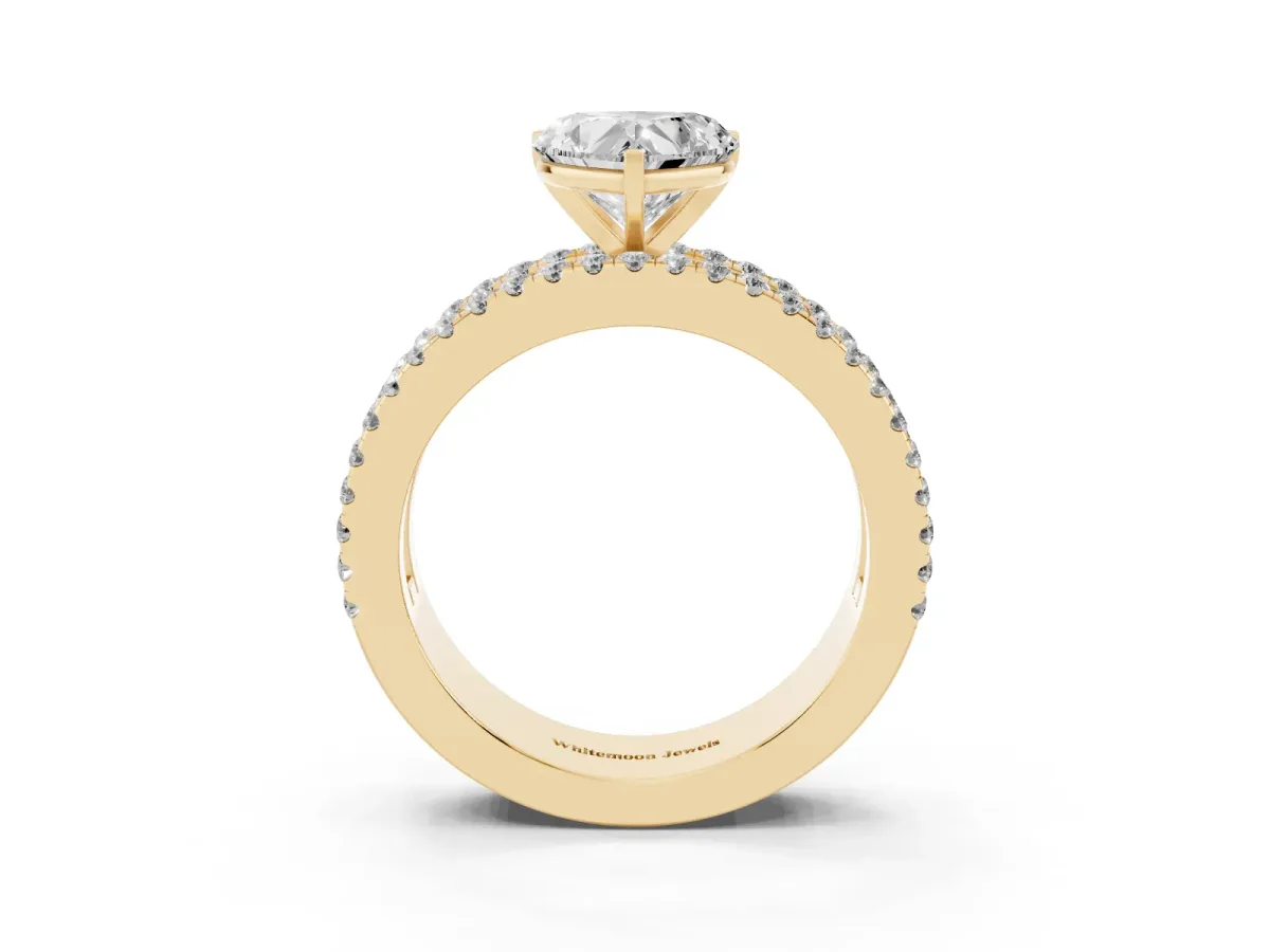 Heart Cut Diamond Solitaire Ring with Pavé and Channel Set Band Yellow gold