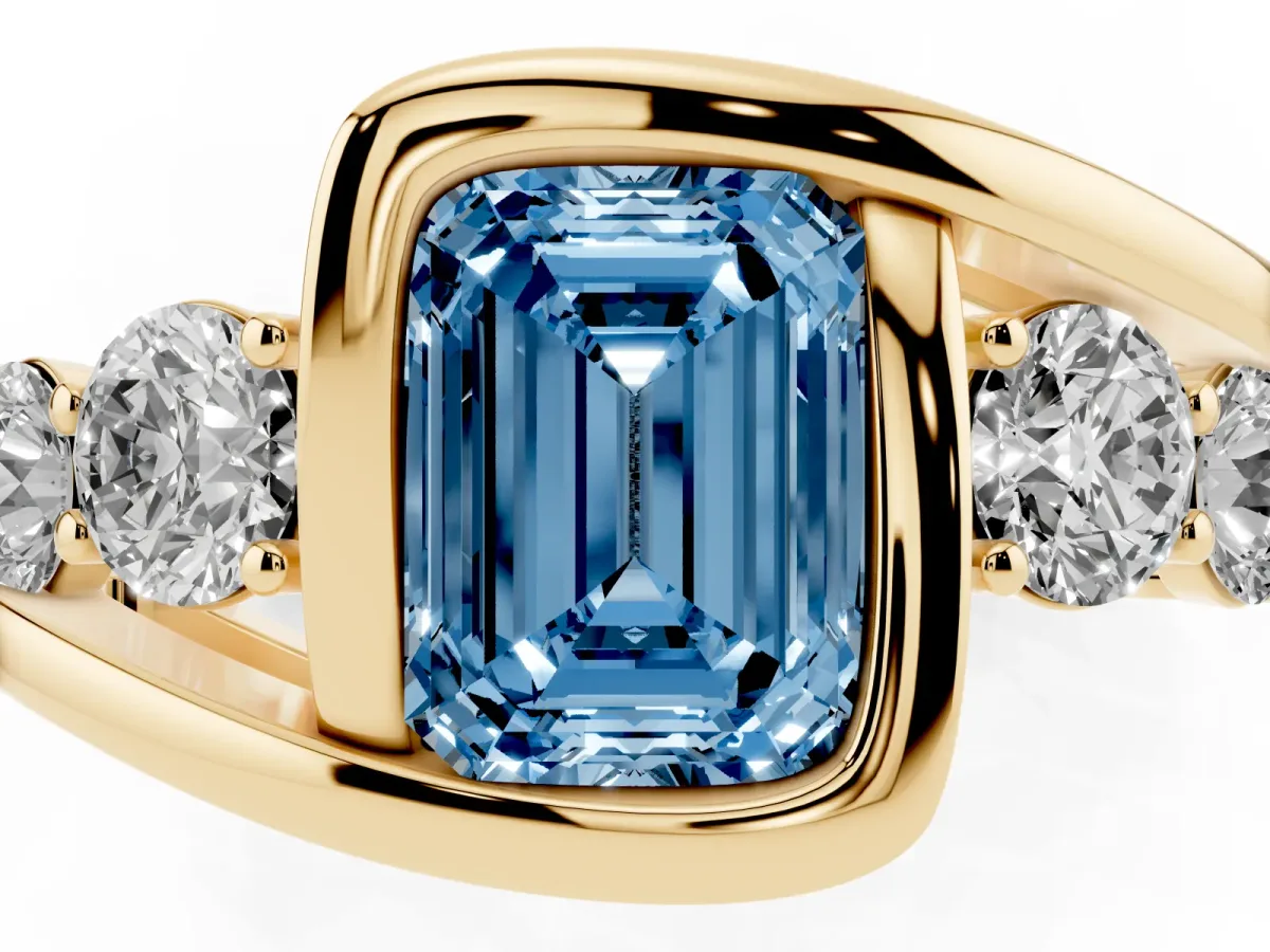 Fancy Blue Bezel Set Emerald Cut Diamond Bypass Ring with Round Accents Yellow gold