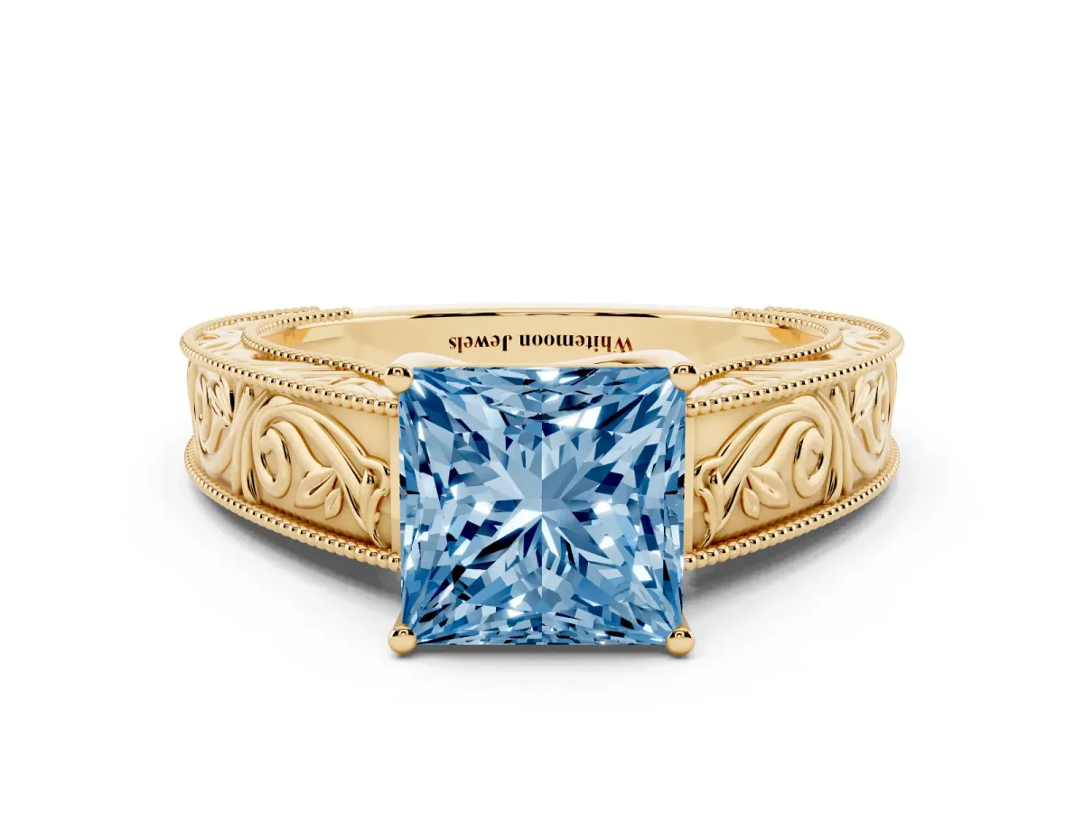 Fancy Blue Princess Cut Diamond Solitaire Ring with Engraved Band and Four-Prong Setting Yellow gold